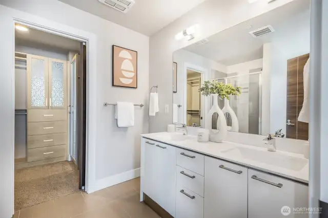 Primary bathroom includes dual-sink vanity and generous storage, blending convenience with thoughtful design