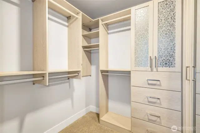 Walk-in closet includes custom California Closets systems for tailored storage and optimized organization