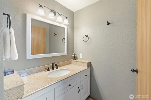 Updated primary bathroom with tile floors and updated vanity