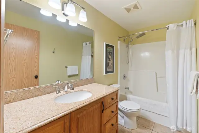Updated main bathroom with tile floors and updated vanity