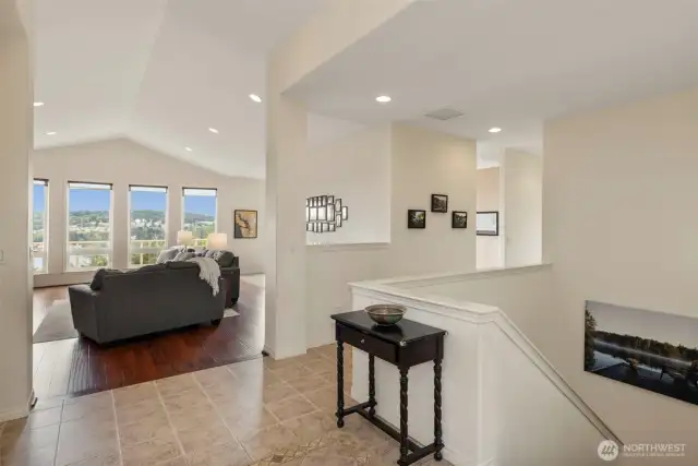 Light and bright, the entry is filled with architectural details everywhere you look. On the right, the stairs wind to the lower level.
