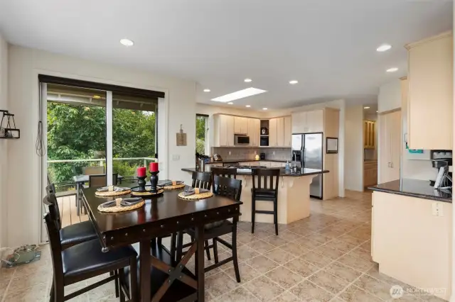 The eating nook opens onto a covered seating area on the deck, perfect for warm weather dining, and convenient to the kitchen.