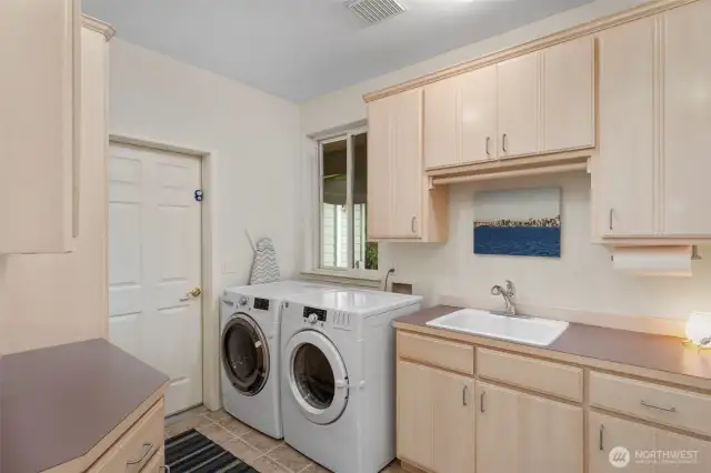 Off the entry hall, this is the laundry room of your dreams! It's large size provides ample storage and miles of counters.