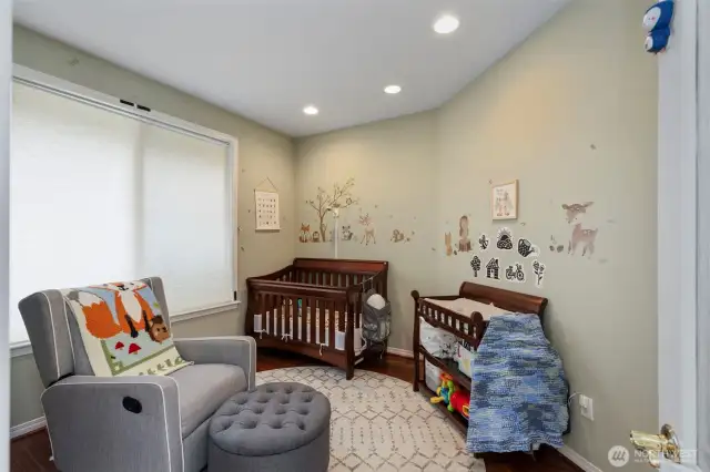 The front bedroom/office has a roomy closet and warm-toned engineered HW floors.