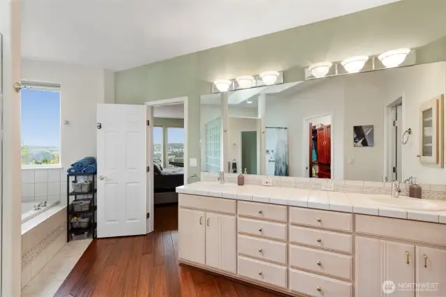 This view illustrates the comfortable size of this room, and the double vanity cabinetry provides plenty of storage.