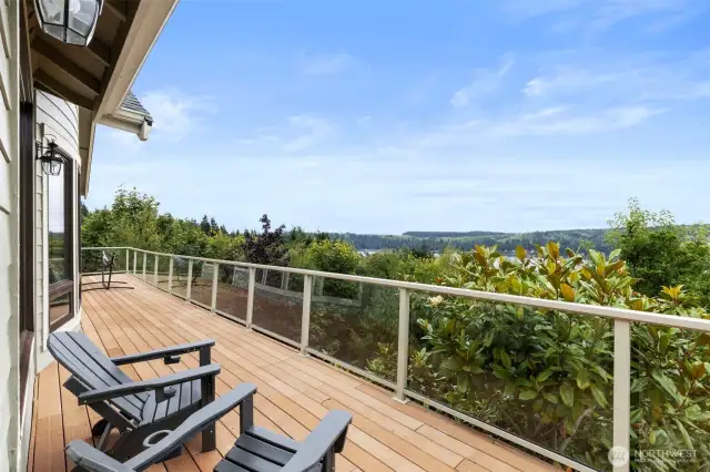 The deck stretches across the entire back of the house and wraps around to the garage on the other side. A stairway takes you to the lower level deck and back yard.