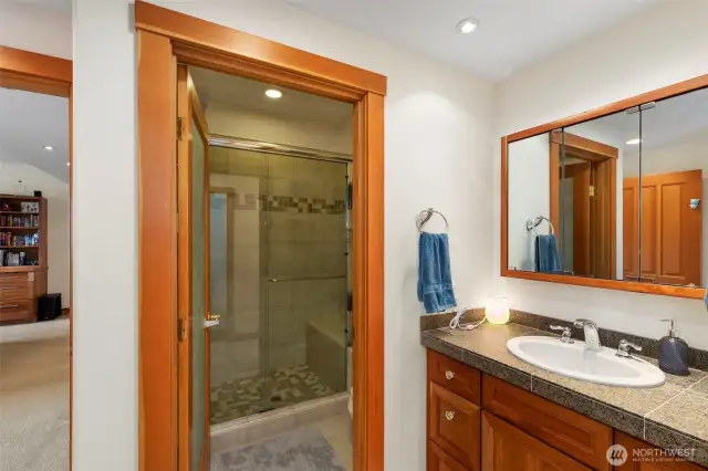 This 3/4 bath off the rec room boasts updated tile shower. On the other side of the room is access to two storage areas and utility room.