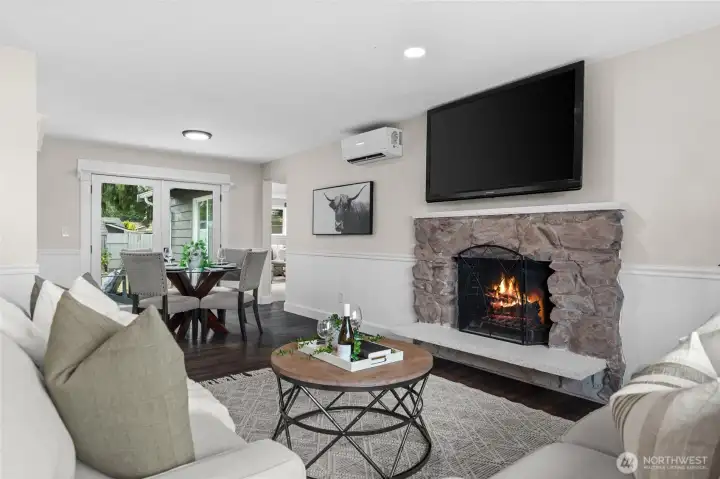 A wood burning stone fireplace has been modernized with a stone hearth and mantle.  A new plasma television adds an element of convenience to this cozy room, especially during the rainy season where you can enjoy the sound of crackling firewood.