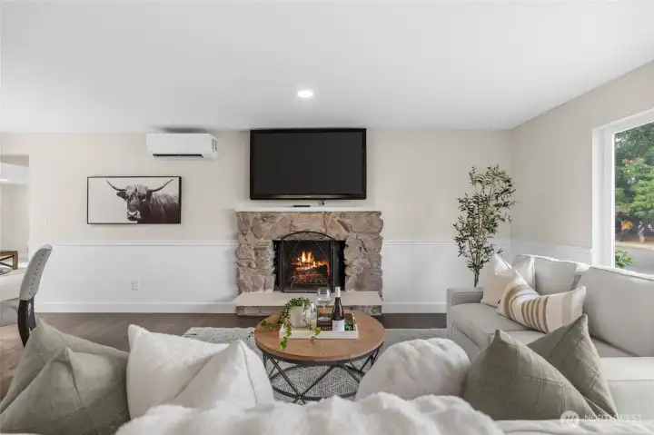 A large picture window in this room fills the home with bright natural light.