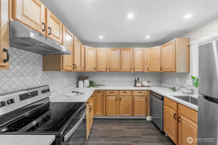 Abundant upper and lower cabinet space offers ample room for all your cooking essentials. Sleek stainless steel and black appliances add a modern touch, seamlessly complementing the new black hardware featured throughout the home — including on doors, cabinets, and light fixtures.