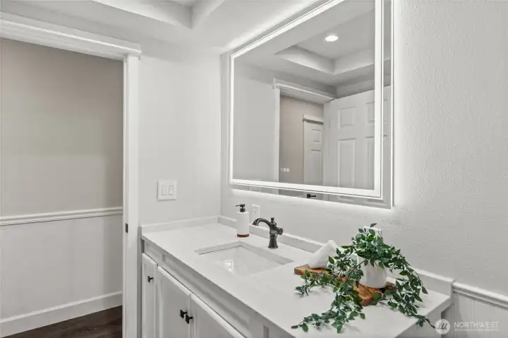 This energy efficient LED vanity mirror offers shadow free illumination while also adding a modern flair to this well used room.