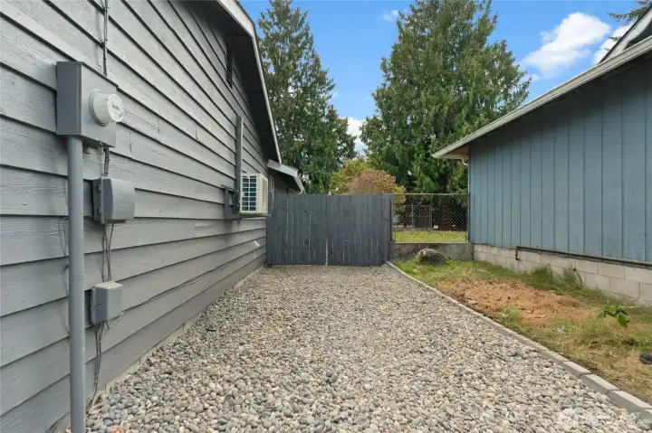 A large graveled area to the right of the home provides additional space for parking.