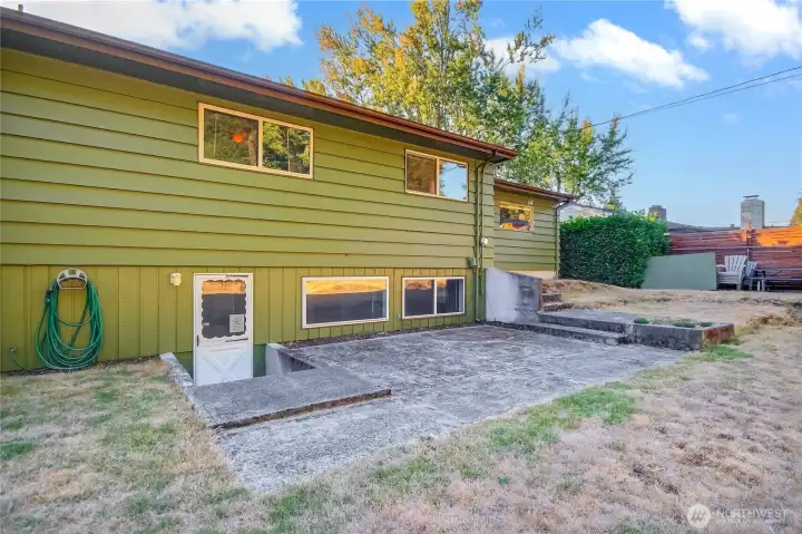 Back of home with large patio. door to basement
