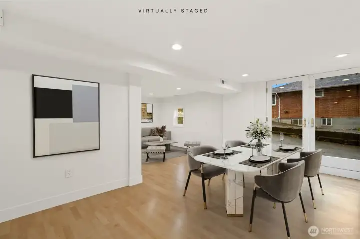 The lower level has its own private entrance and offers a fully finished bedroom with a living area, full bath, laundry hookups, and rough-ins for a complete kitchen.