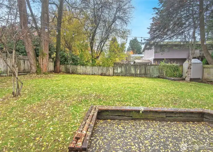 Back patio, fenced back yard and mature landscaping.