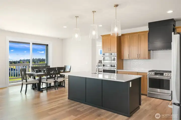 View from the open great room seamlessly connecting the living, dining and kitchen spaces.