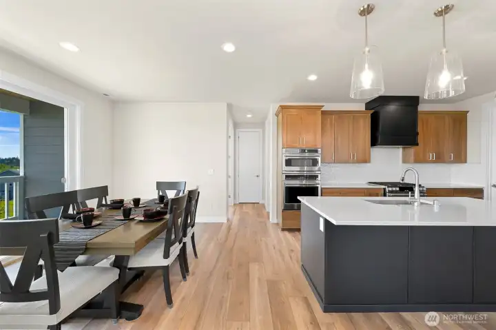 Modern kitchen with a large island, pendent lighting and seamless flow into the dining area.