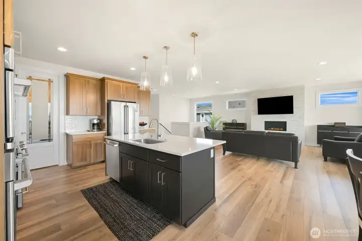 Spacious kitchen with generous island overlooking the great room ideal for gathering, cooking and entertaining.