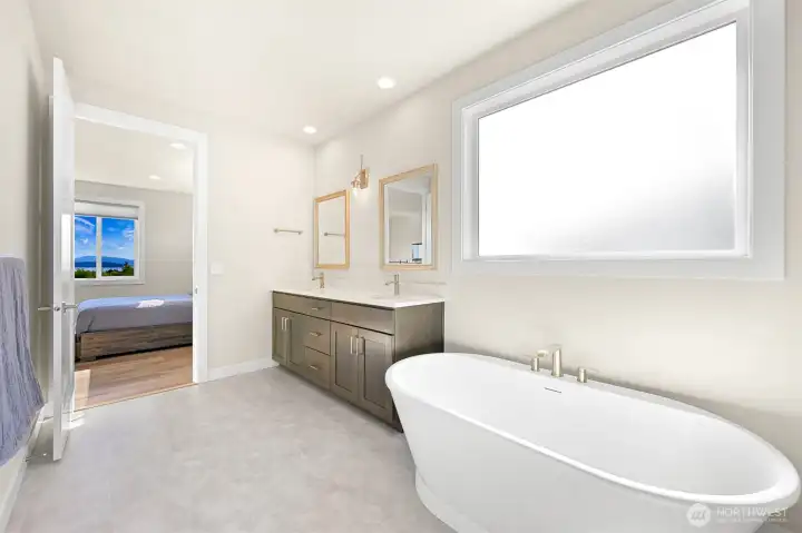 Owners' suite bath with clean modern lines and a free-standing soaking tub.