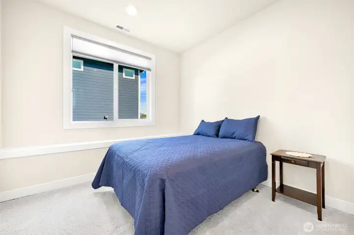 Comfortable ground level 4th bedroom with flexibility perfect for guests, office, media room or private retreat.