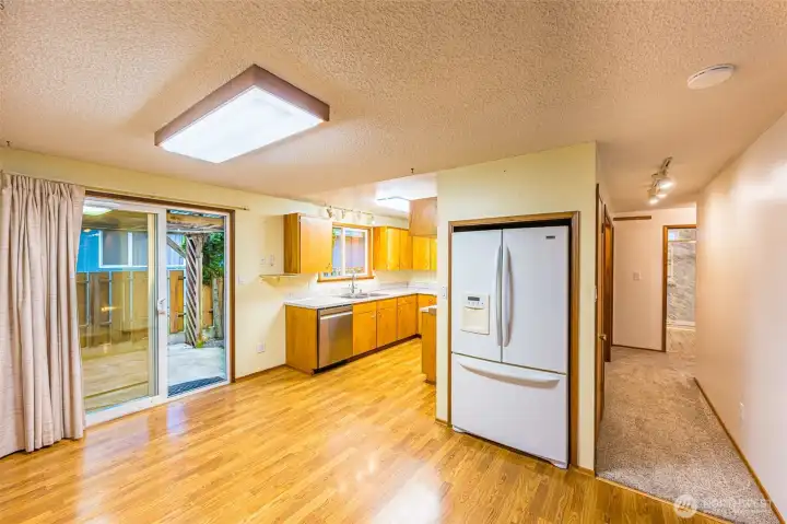 Sparkling clean and ready to move-in. View to kitchen and hallway to bedrooms.