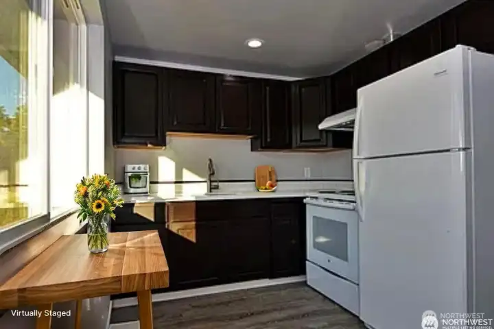 Lovely kitchen with southern exposore windows let light pour in. (Virtually staged)