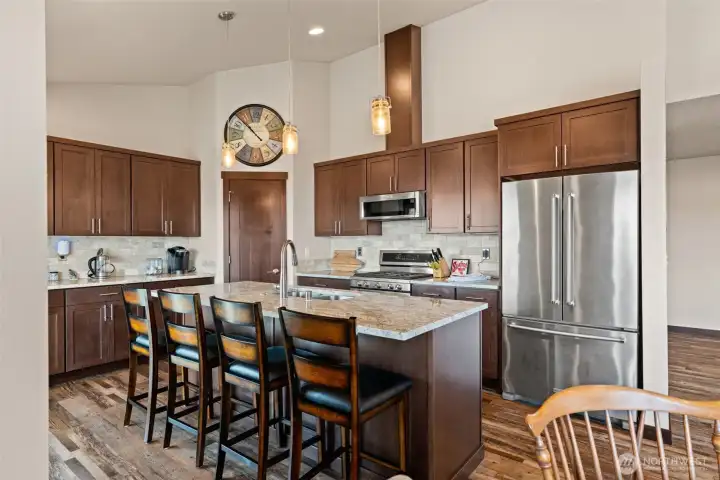 Kitchen with center island, stainless appliances, granite counters, walk-in pantry.