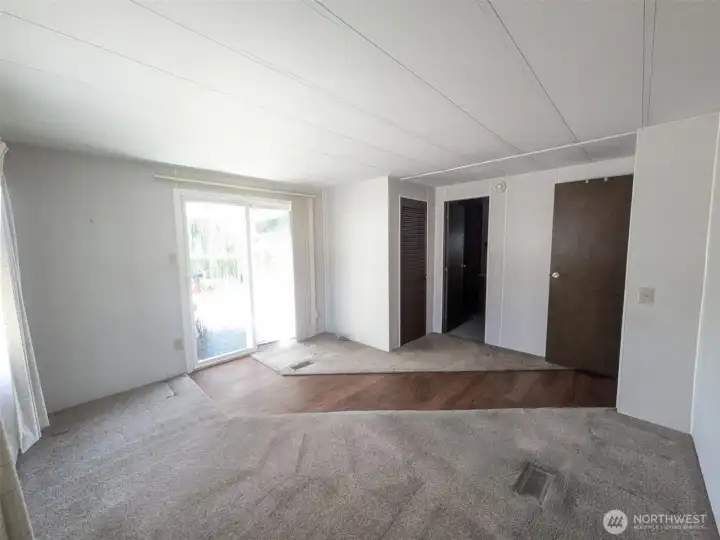 Primary bedroom with 3/4 bath and walk-in closet. Extra closet in bathroom. Sliding doors to backyard patio.