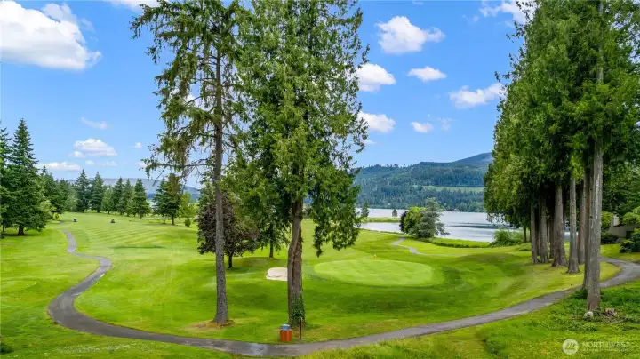 Sweeping golf course, lake, and mountain views create a spectacular backdrop from this elevated condo setting.