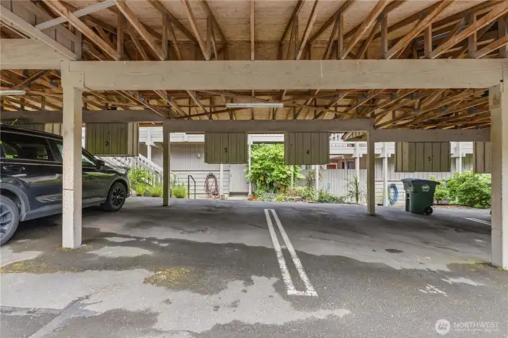 Covered parking with storage provides convenient, protected access year-round with dedicated parking and guest spaces nearby.