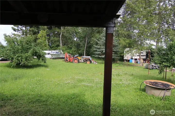 Looking out from the entry.  An included lot is in the background beyond the boat and tractor