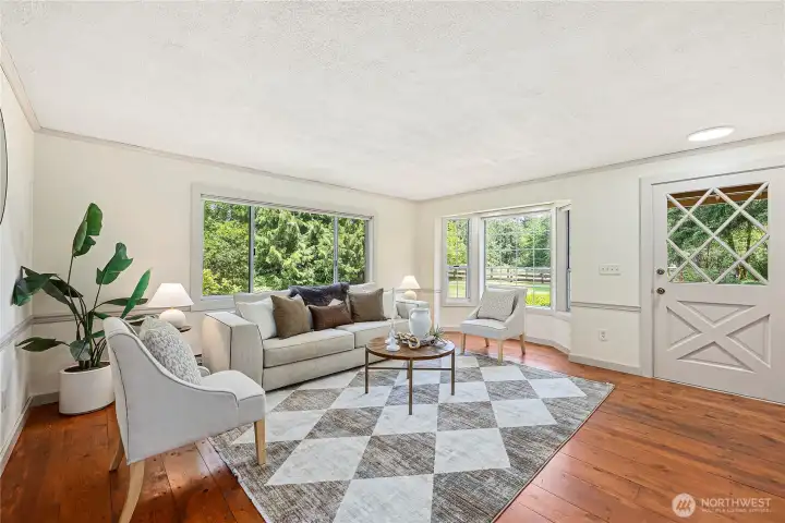 You immediately notice the large plank real hardwood floors, bay window facing the front