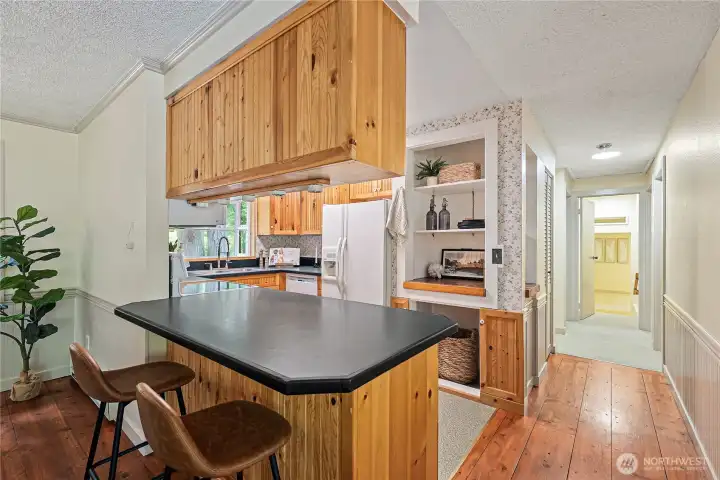 Kitchen counter with seating area and beautiful wood cabinetry