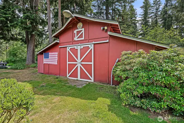 Large barn that once held animals and currently holds a workshop