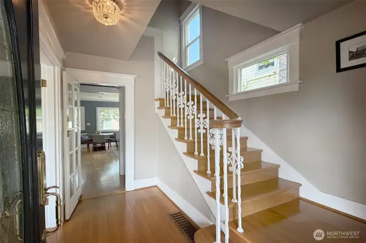 Gracious and open stairwell to upper floors, and to formal living & dining rooms.