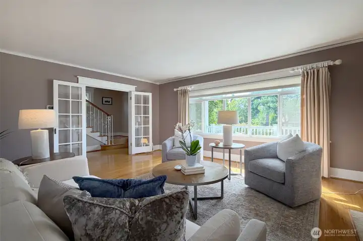 French doors leads to the foyer and open staircase up.