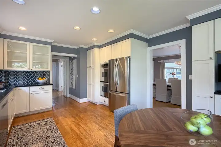 Updated kitchen with beautiful white cabinetry, tons for storage, hardwood floors & even an eating space!