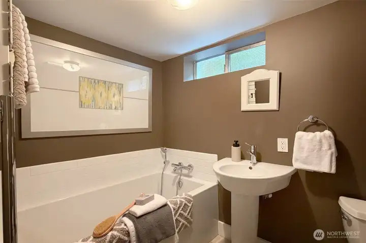 Richly accented uipdated full bath on lower level.