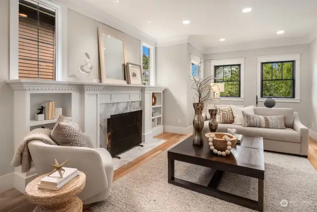 Entering through the front door you immediately feel the warmth of the of the sun-drenched living room. And on chilly days enjoy the beautiful marble framed wood-burning fireplace- plumbed for gas. The entire main floor features new hardwood floors.