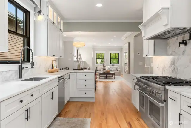 The Chef's kitchen with marble counter tops, custom cabinetry, all new Thermador stainless appliances including a 6 burner range and a full-height refrigerator/freezer, along with abundant counter space.