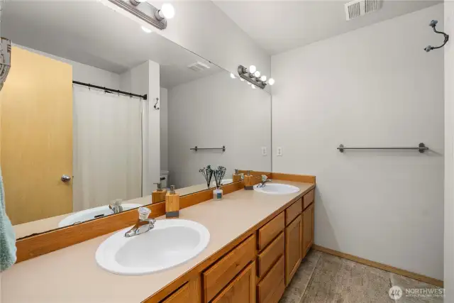 Ensuite bathroom has a double vanity and tub/shower combo