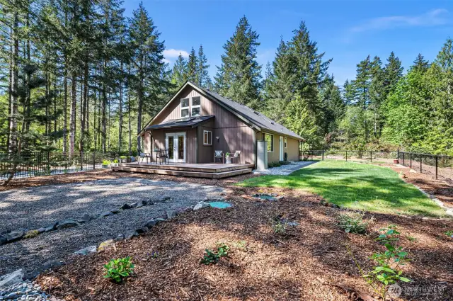 Low maintenance fully-fenced yard provides a grassy areza to play and garden space