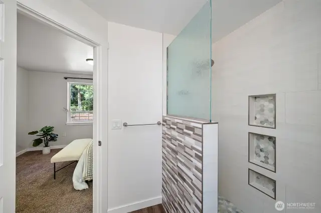 Tiled walk-in shower in the primary suite.