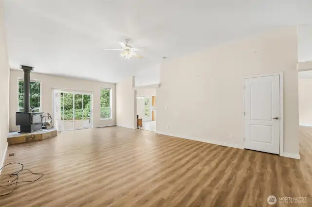 The Great Room has a wood burning stove and access to the16.6x55 Timber Teck deck and backyard with fire pit and hot tub.