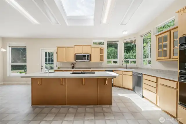 Extra large island in the kitchen has an extra sink and one of the 2 ranges.