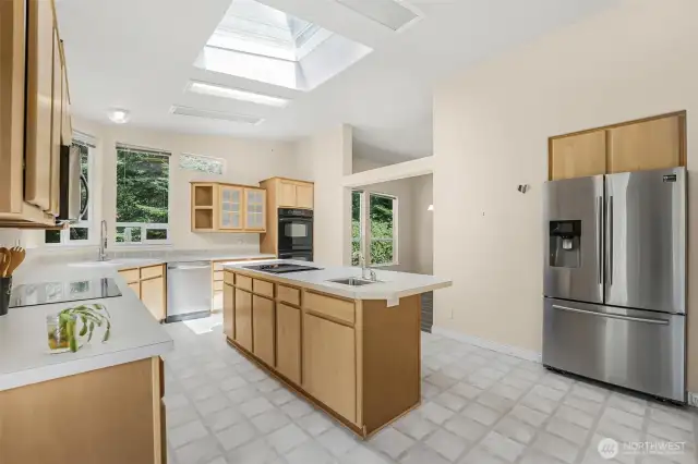 The kitchen features double ovens, two ranges, microwave, trash compactor, garbage disposal, two sinks, inset refrigerator and gourmet Butler's Pantry.