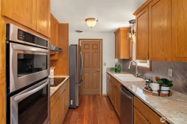 Kitchen features sheet metal backsplash custom built by a mechanic.
