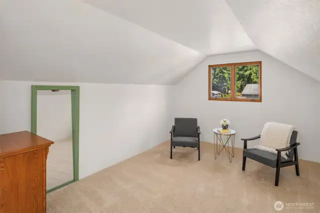 Sitting area in primary bedroom with gas fireplace.