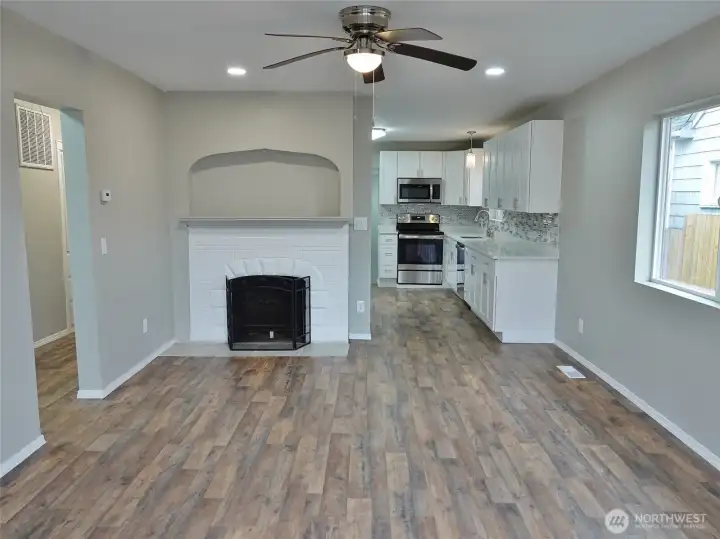 Living Room w/ ceiling fan and classic fireplace.