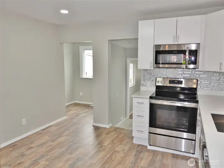 Kitchen ... leads into the Dining Nook (left) and the Laundry Room (right).